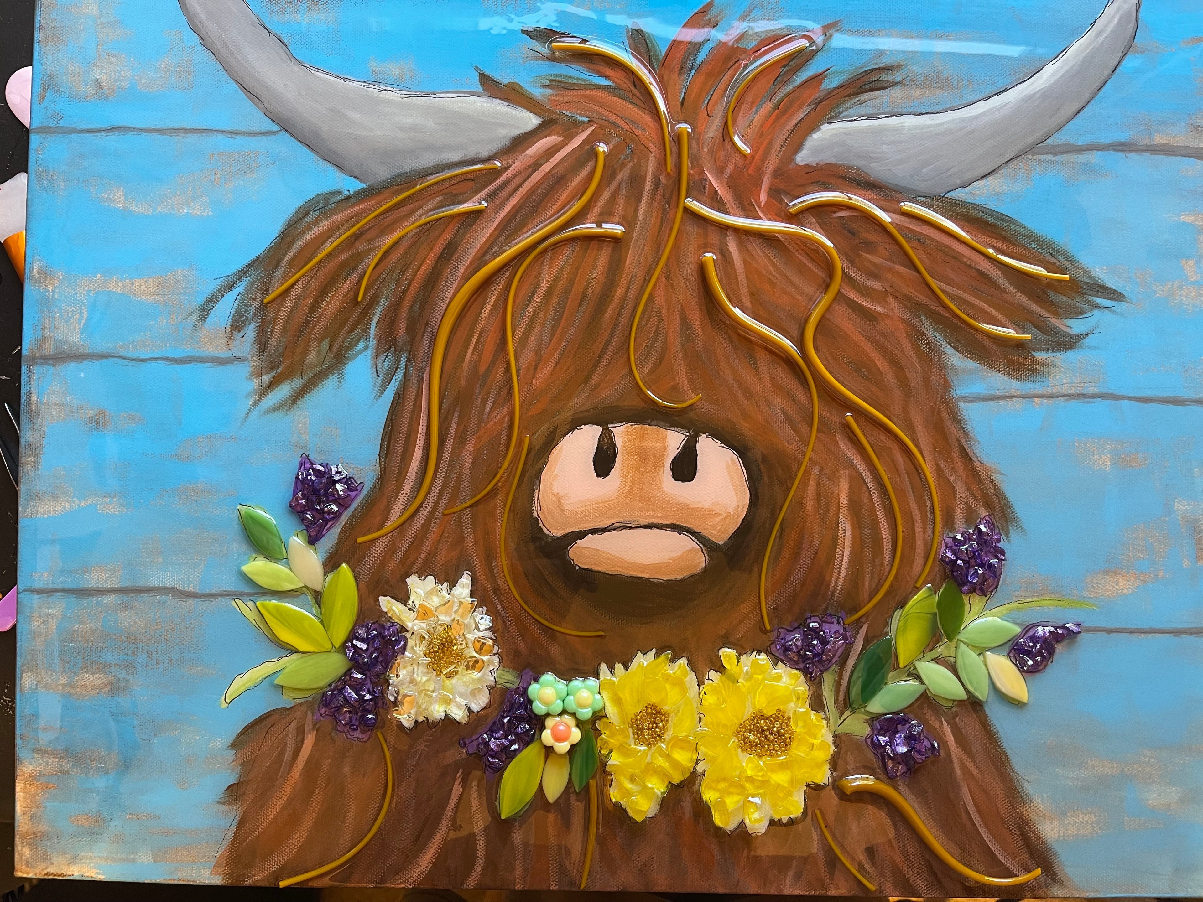 highland cow with flower lei