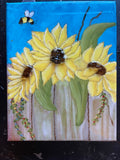 sunflowers on fence